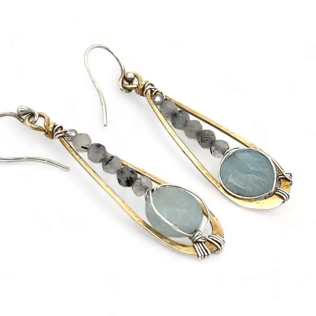 Aquamarine coins and black tourmaline quartz faceted gemstones in brass drop earrings with sterling silver wire.