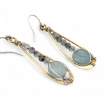 Aquamarine coins and black tourmaline quartz faceted gemstones in brass drop earrings with sterling silver wire.