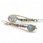 Aquamarine coins and black tourmaline quartz faceted gemstones in brass drop earrings with sterling silver wire.