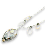 Charm necklace with bronze, sterling silver, and darkened sterling braided petal shapes, accompanied by opal, a carved aquamarine flower, apatite, and crystal gemstones