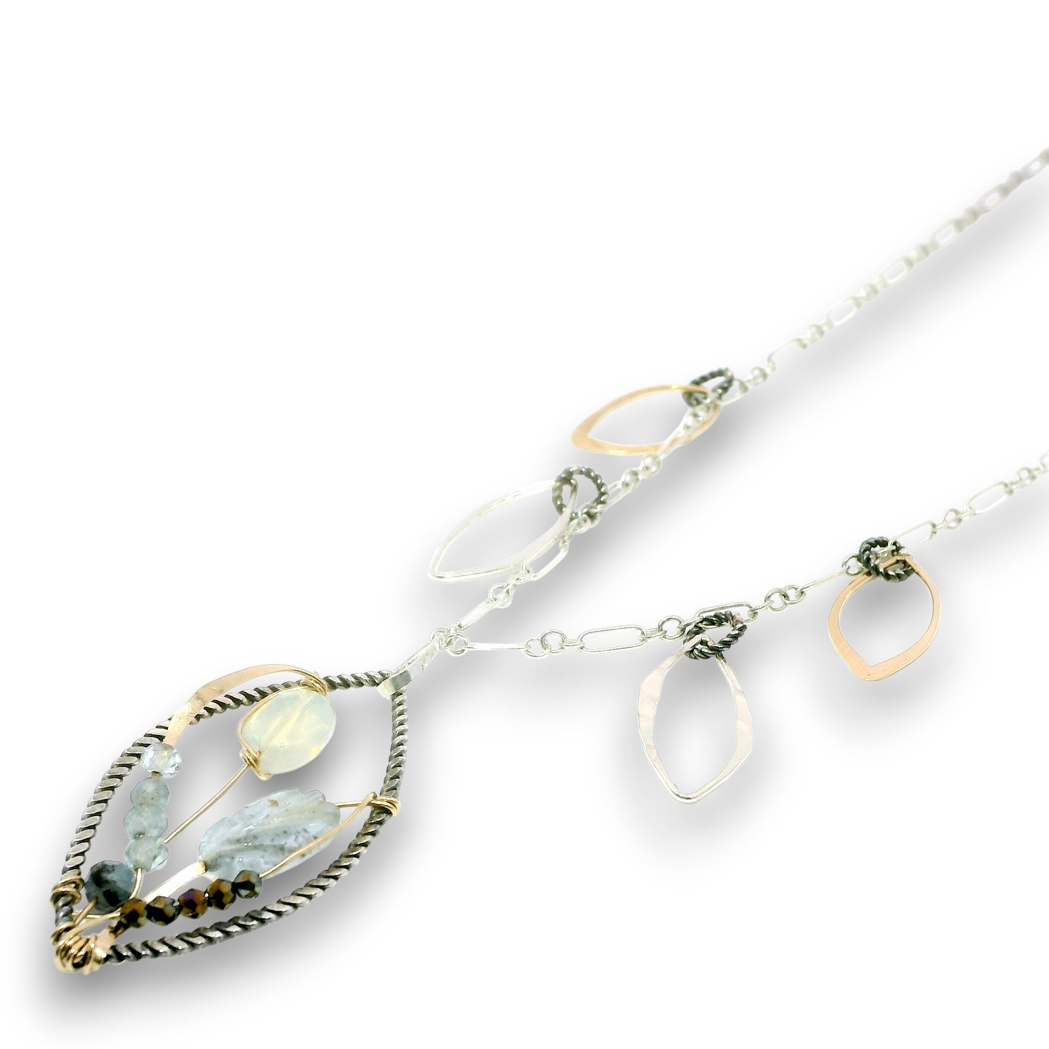 Charm necklace with bronze, sterling silver, and darkened sterling braided petal shapes, accompanied by opal, a carved aquamarine flower, apatite, and crystal gemstones