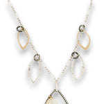 Charm necklace with bronze, sterling silver, and darkened sterling braided petal shapes, accompanied by opal, a carved aquamarine flower, apatite, and crystal gemstones