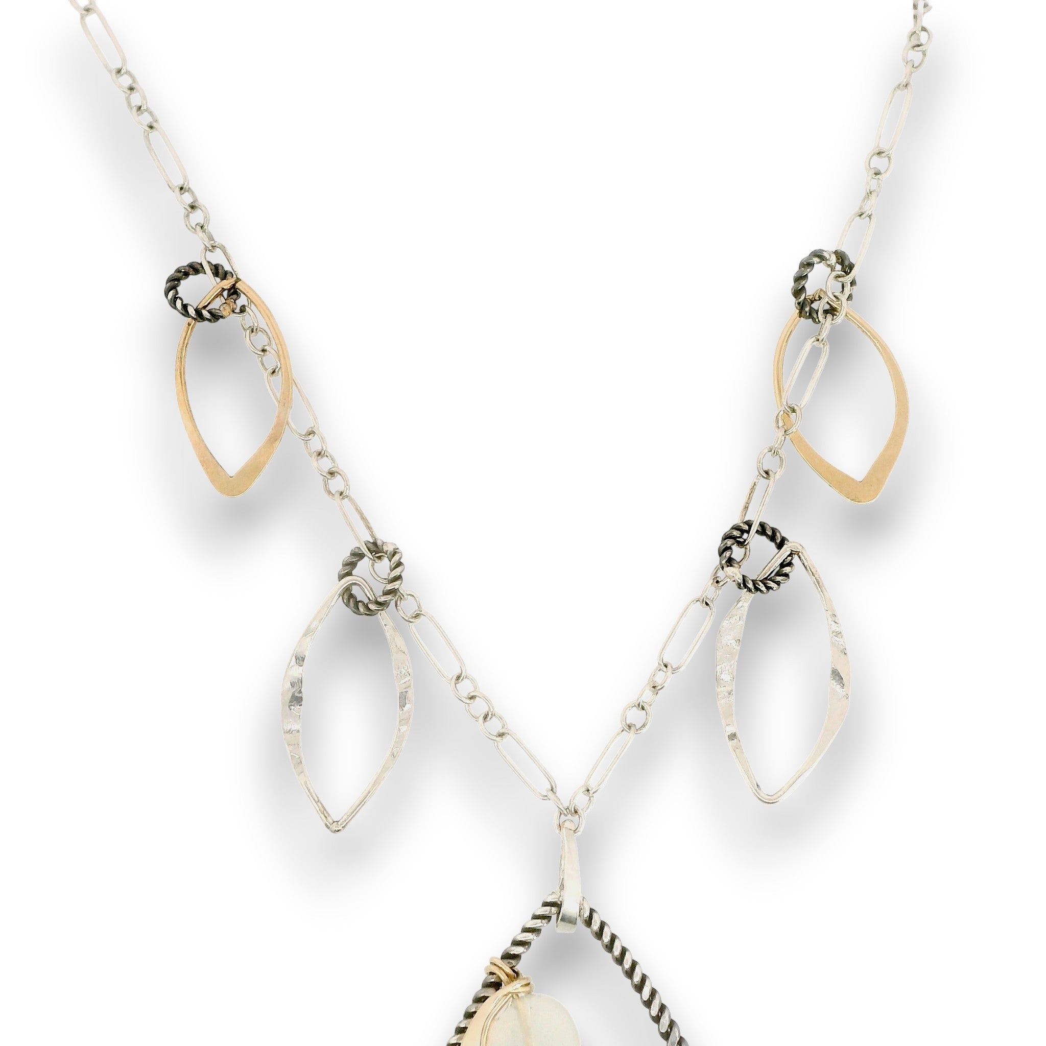 Charm necklace with bronze, sterling silver, and darkened sterling braided petal shapes, accompanied by opal, a carved aquamarine flower, apatite, and crystal gemstones