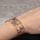 Wide bronze double cuff with sterling silver hammered bars decorated in a plaid pattern with aquamarine, moonstone, labradorite, apatite, and iolite gemstones