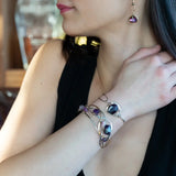 Sterling silver cuff bracelet with a large faceted dark purple amethyst gemstone nugget wrapped in bronze wire