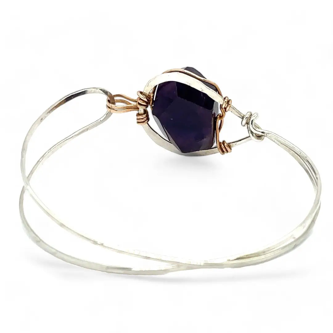 Sterling silver cuff bracelet with a large faceted dark purple amethyst gemstone nugget wrapped in bronze wire