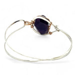 Sterling silver cuff bracelet with a large faceted dark purple amethyst gemstone nugget wrapped in bronze wire