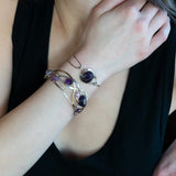 Sterling silver cuff bracelet with a large faceted dark purple amethyst gemstone nugget wrapped in bronze wire