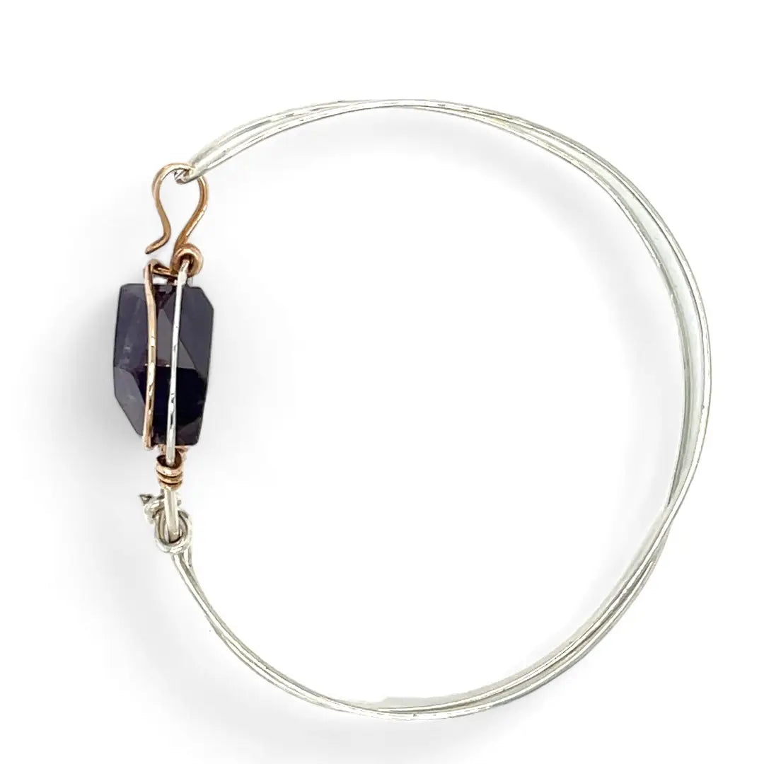 Sterling silver cuff bracelet with a large faceted dark purple amethyst gemstone nugget wrapped in bronze wire