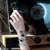 Sterling silver cuff bracelet with a large faceted dark purple amethyst gemstone nugget wrapped in bronze wire