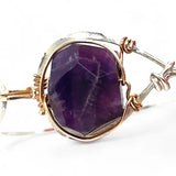 Sterling silver cuff bracelet with a large faceted dark purple amethyst gemstone nugget wrapped in bronze wire