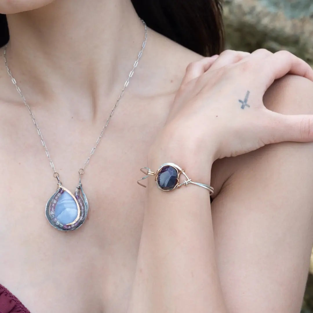 Sterling silver cuff bracelet with a large faceted dark purple amethyst gemstone nugget wrapped in bronze wire