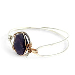 Sterling silver cuff bracelet with a large faceted dark purple amethyst gemstone nugget wrapped in bronze wire