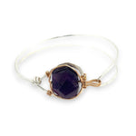 Sterling silver cuff bracelet with a large faceted dark purple amethyst gemstone nugget wrapped in bronze wire