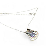 A blue/purple rectangular crystal is held in layers of sterling silver and bronze hammered wire pendant on sterling silver delicate chain necklace