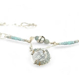 A sterling silver double strand necklace with chain links, twisted knot, amazonite, and aquamarine gemstones, featuring a blue rhomboid crystal pendant.