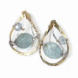 Aquamarine smooth oval gemstone earrings with a faceted blue crystal and wrapped in hammered sterling silver in a tree stamped brass drop earring with built in earring hooks that wear like a post earring