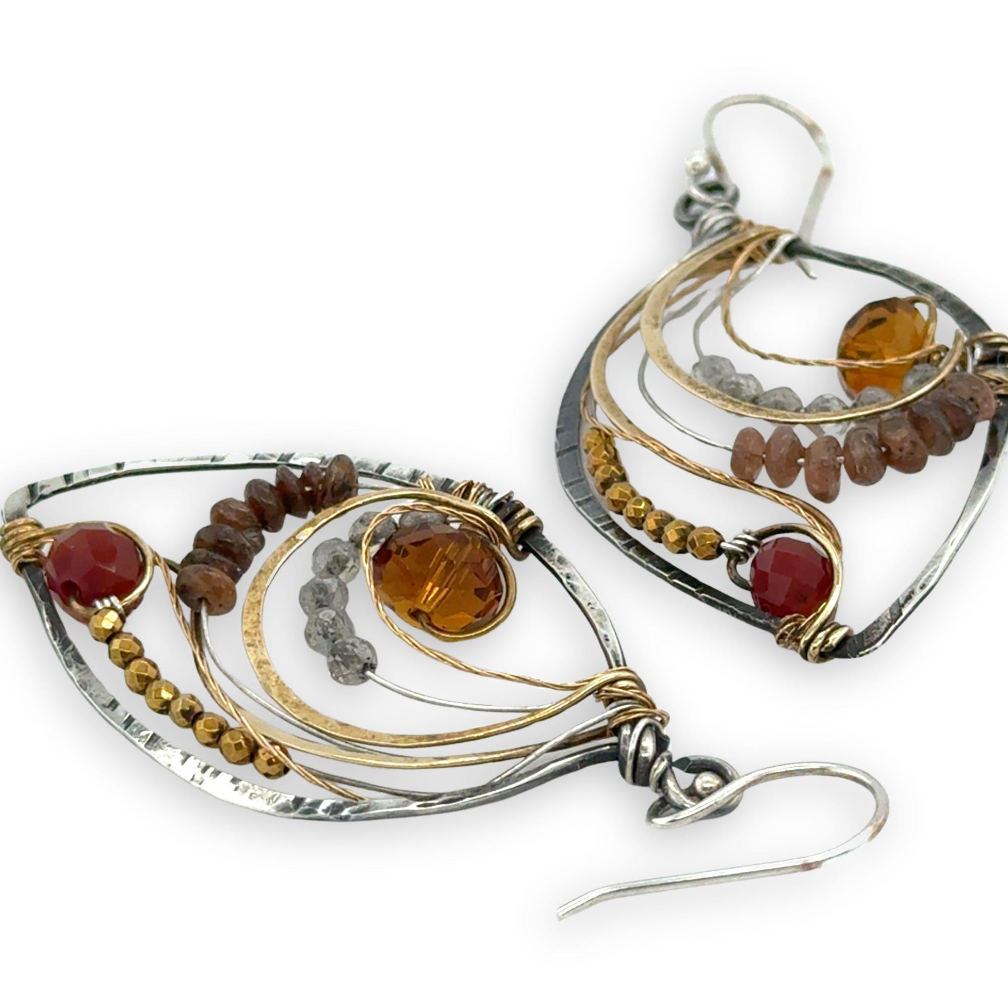 Labradorite, smokey quartz, and pyrite gemstones line autumn amber colored crystals within oxidized sterling silver drop earrings accented with brass and brass twist wire