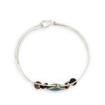 azurite teardrop gemstone at the center of sterling silver bracelet wrapped in brass hammered wire with tiger's eye accent