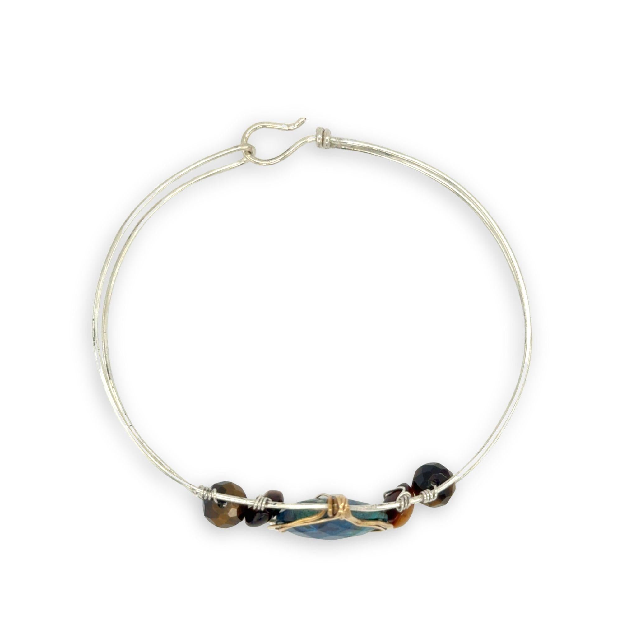 azurite teardrop gemstone at the center of sterling silver bracelet wrapped in brass hammered wire with tiger's eye accent