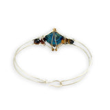 azurite teardrop gemstone at the center of sterling silver bracelet wrapped in brass hammered wire with tiger's eye accent