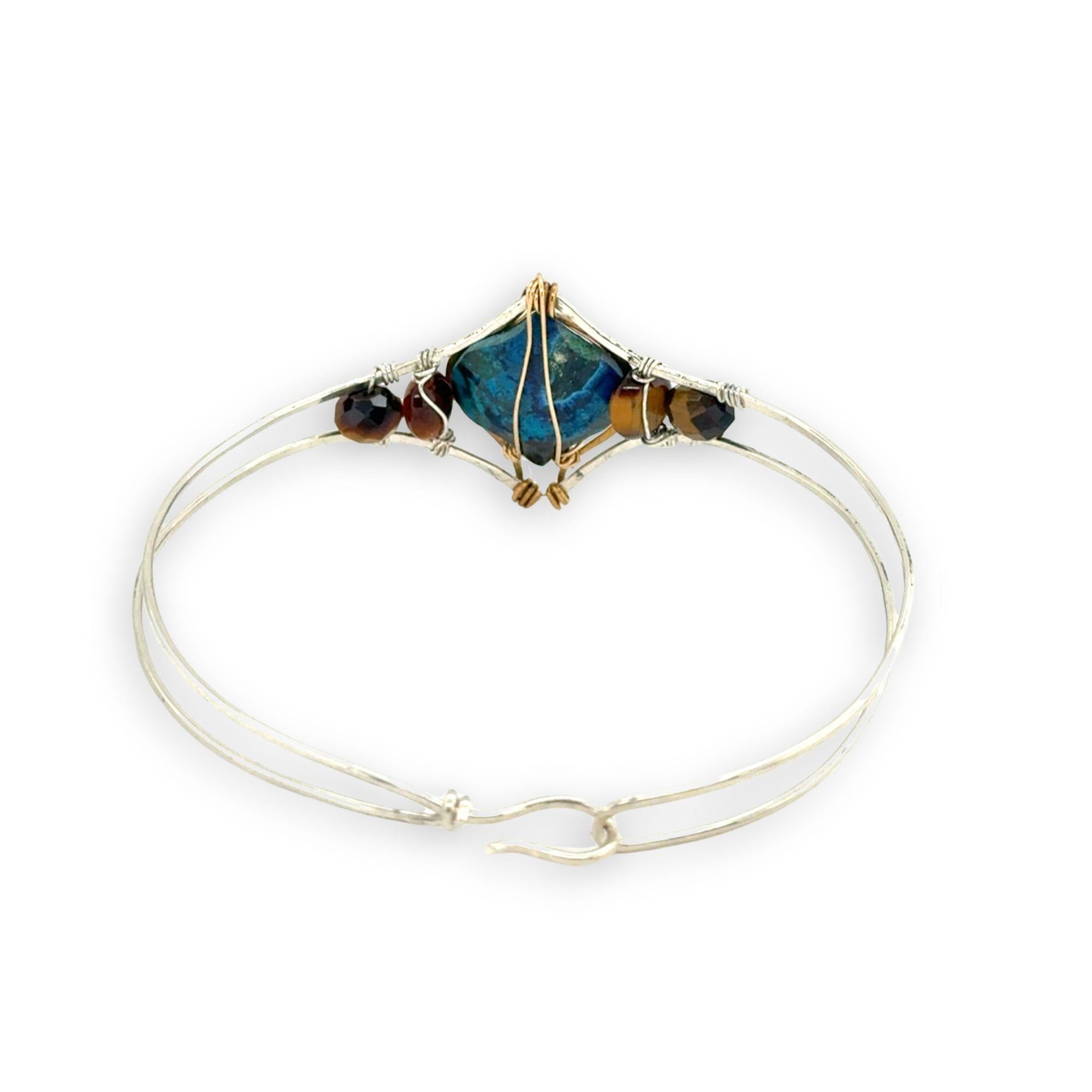 azurite teardrop gemstone at the center of sterling silver bracelet wrapped in brass hammered wire with tiger's eye accent