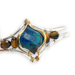azurite teardrop gemstone at the center of sterling silver bracelet wrapped in brass hammered wire with tiger's eye accent