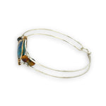 azurite teardrop gemstone at the center of sterling silver bracelet wrapped in brass hammered wire with tiger's eye accent