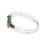 azurite teardrop gemstone at the center of sterling silver bracelet wrapped in brass hammered wire with tiger's eye accent