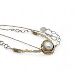 a fresh water pearl is held in a brass knot pendant with opal nugget gemstones on gold filled and sterling silver dash chain necklace