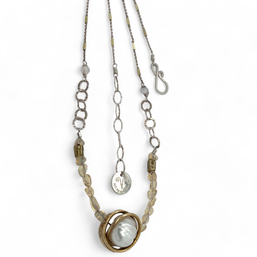 a fresh water pearl is held in a brass knot pendant with opal nugget gemstones on gold filled and sterling silver dash chain necklace