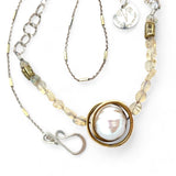 a fresh water pearl is held in a brass knot pendant with opal nugget gemstones on gold filled and sterling silver dash chain necklace