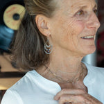 Oxidized sterling silver channel hoop earrings embellished with labradorite gemstones and plum colored crystal drops