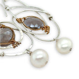 Mauve moonstone faceted coin gemstones are wrapped in brass twist wire attached to a sterling silver earring with a fresh water pearl dangle