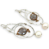 Mauve moonstone faceted coin gemstones are wrapped in brass twist wire attached to a sterling silver earring with a fresh water pearl dangle