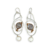 Mauve moonstone faceted coin gemstones are wrapped in brass twist wire attached to a sterling silver earring with a fresh water pearl dangle