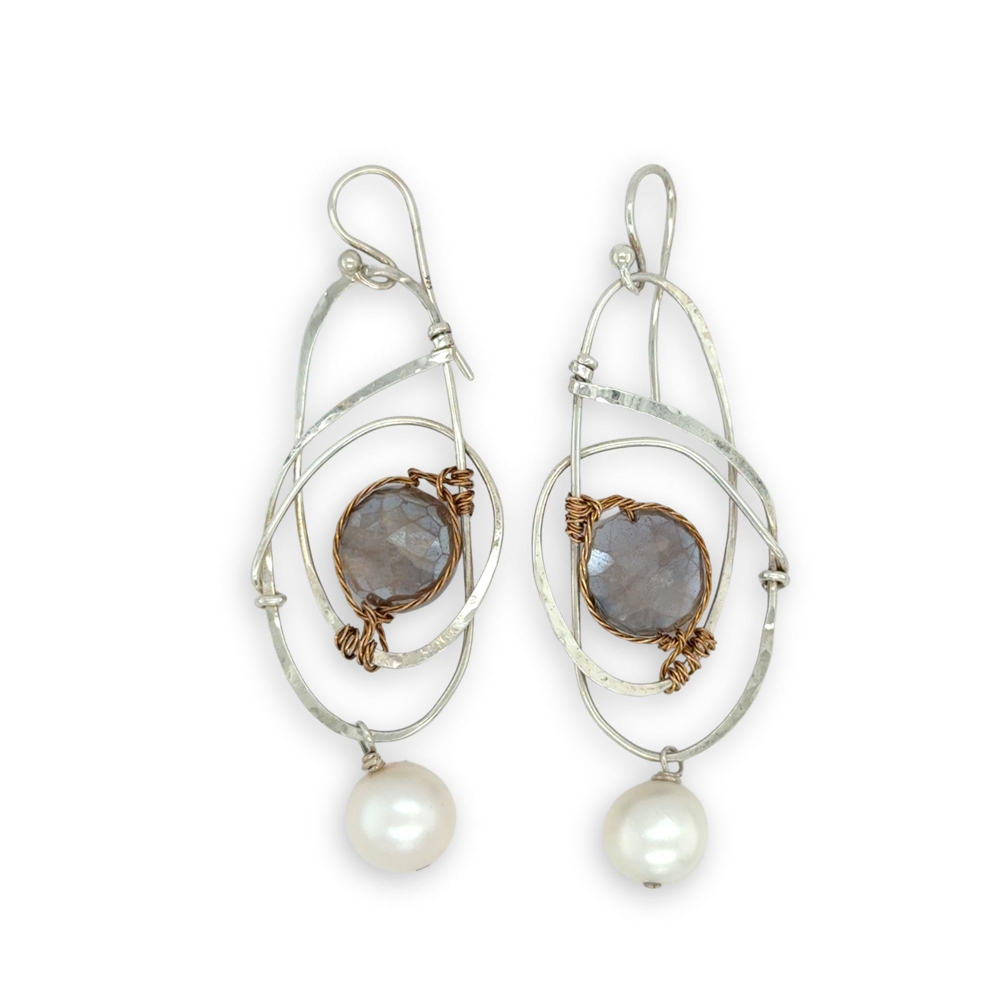 Mauve moonstone faceted coin gemstones are wrapped in brass twist wire attached to a sterling silver earring with a fresh water pearl dangle