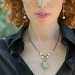 Sterling silver handmade knot pendant holding a lustrous moonstone slab hanging from a ladle of fresh water pearl and moonstone gemstones on a double up darkened sterling silver chain necklace