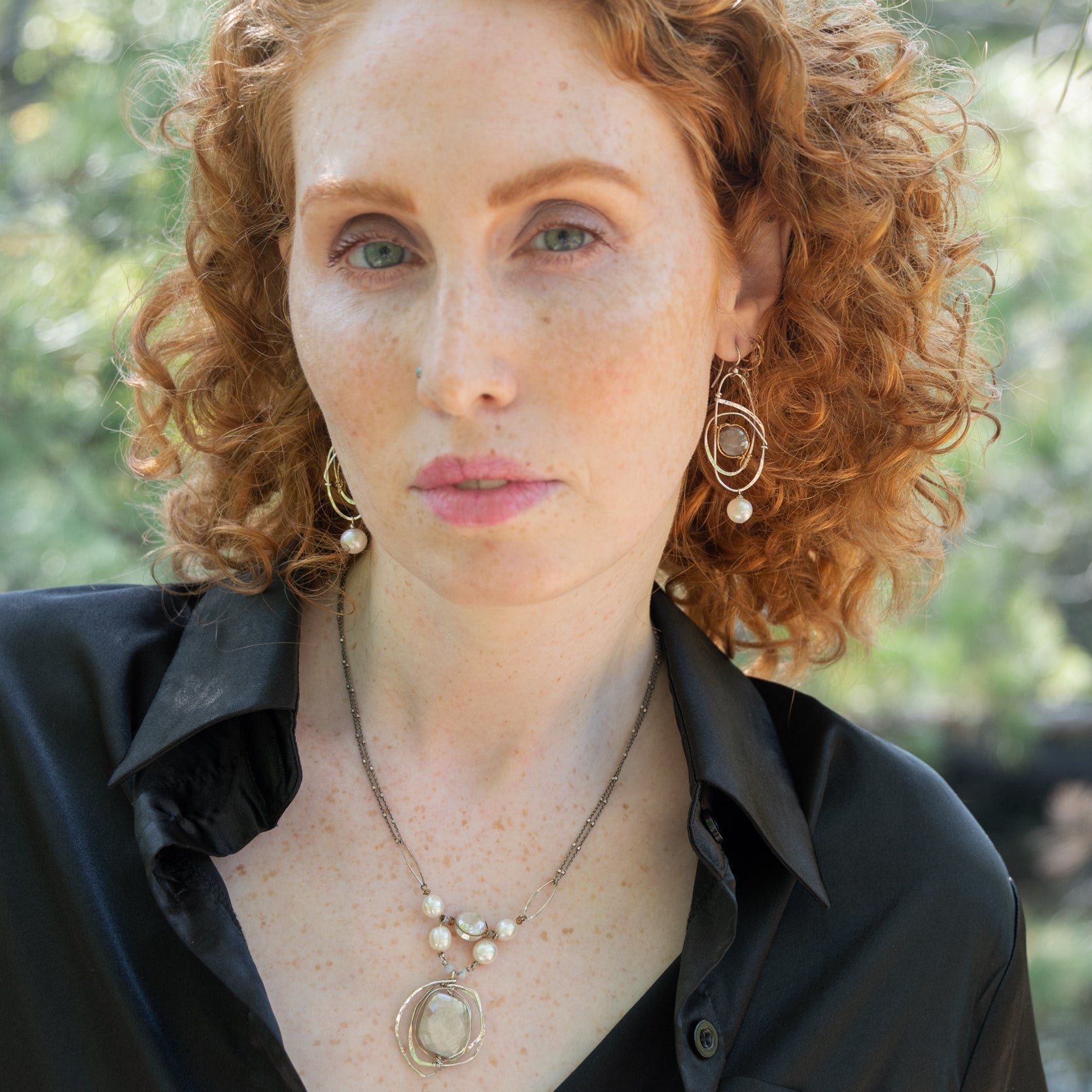 Sterling silver handmade knot pendant holding a lustrous moonstone slab hanging from a ladle of fresh water pearl and moonstone gemstones on a double up darkened sterling silver chain necklace