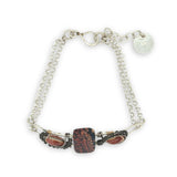 Red fossil jasper, rhodochrosite, and green obsidian gemstones fill the sterling silver bar bracelet with rolo chain backing