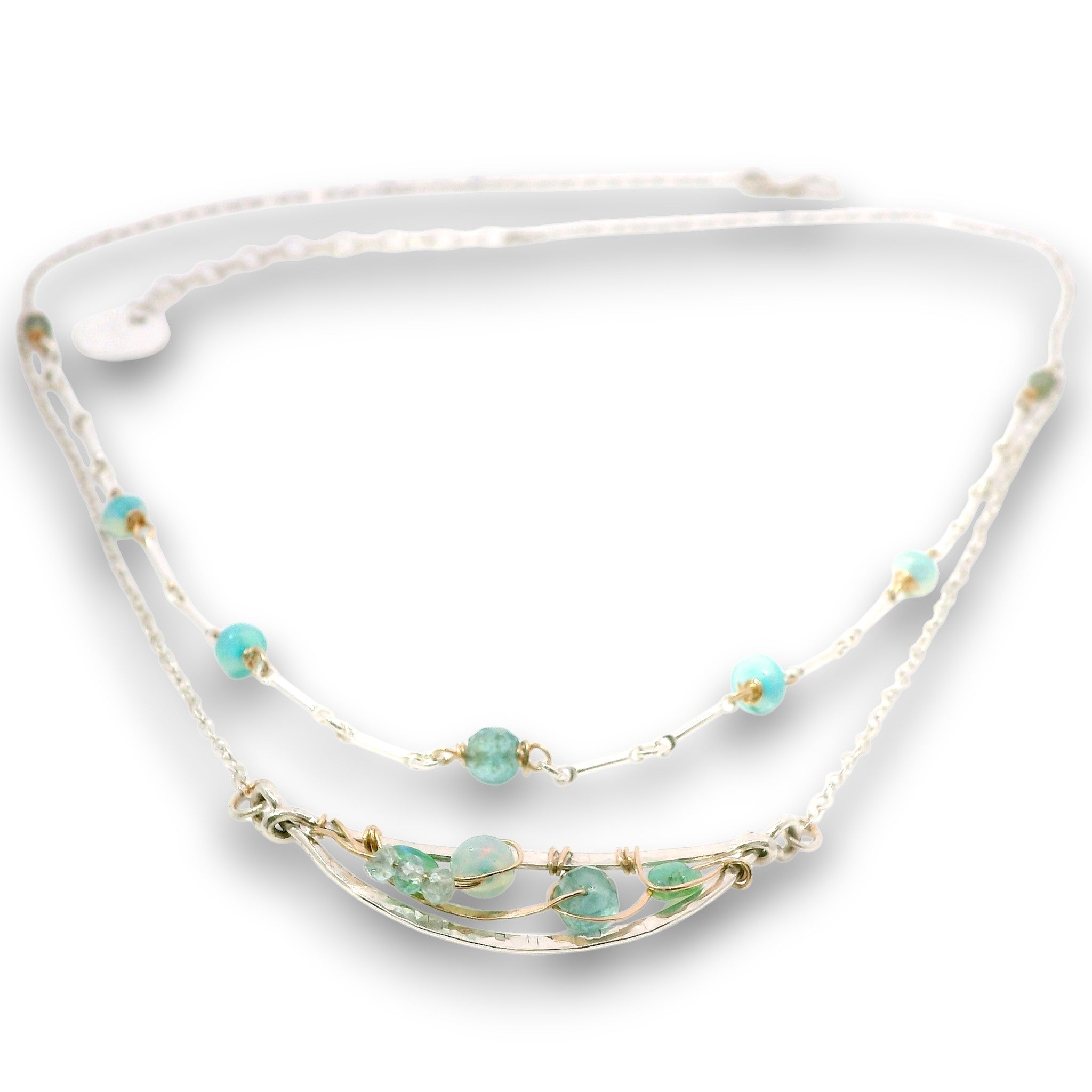 Double layered necklace with the first layer being sterling bar chain with blue opals, the second layer with a sterling moon shaped pendant filled with apatite and bold opal gemstones in 14k gold filled swirls