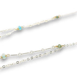 Double layered necklace with the first layer being sterling bar chain with blue opals, the second layer with a sterling moon shaped pendant filled with apatite and bold opal gemstones in 14k gold filled swirls