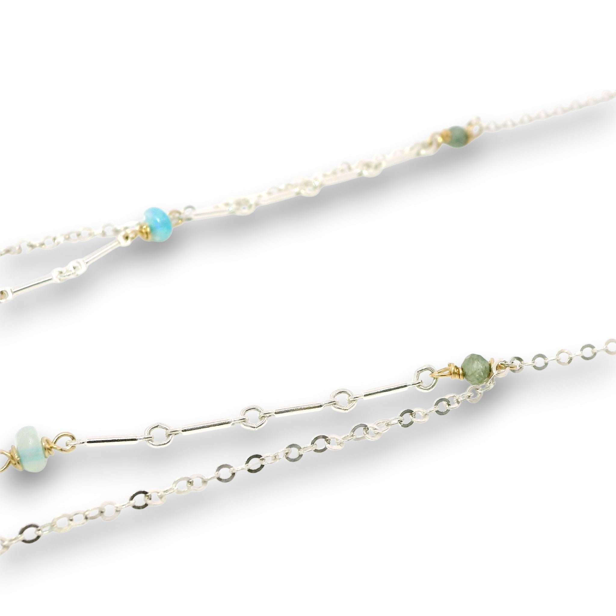 Double layered necklace with the first layer being sterling bar chain with blue opals, the second layer with a sterling moon shaped pendant filled with apatite and bold opal gemstones in 14k gold filled swirls