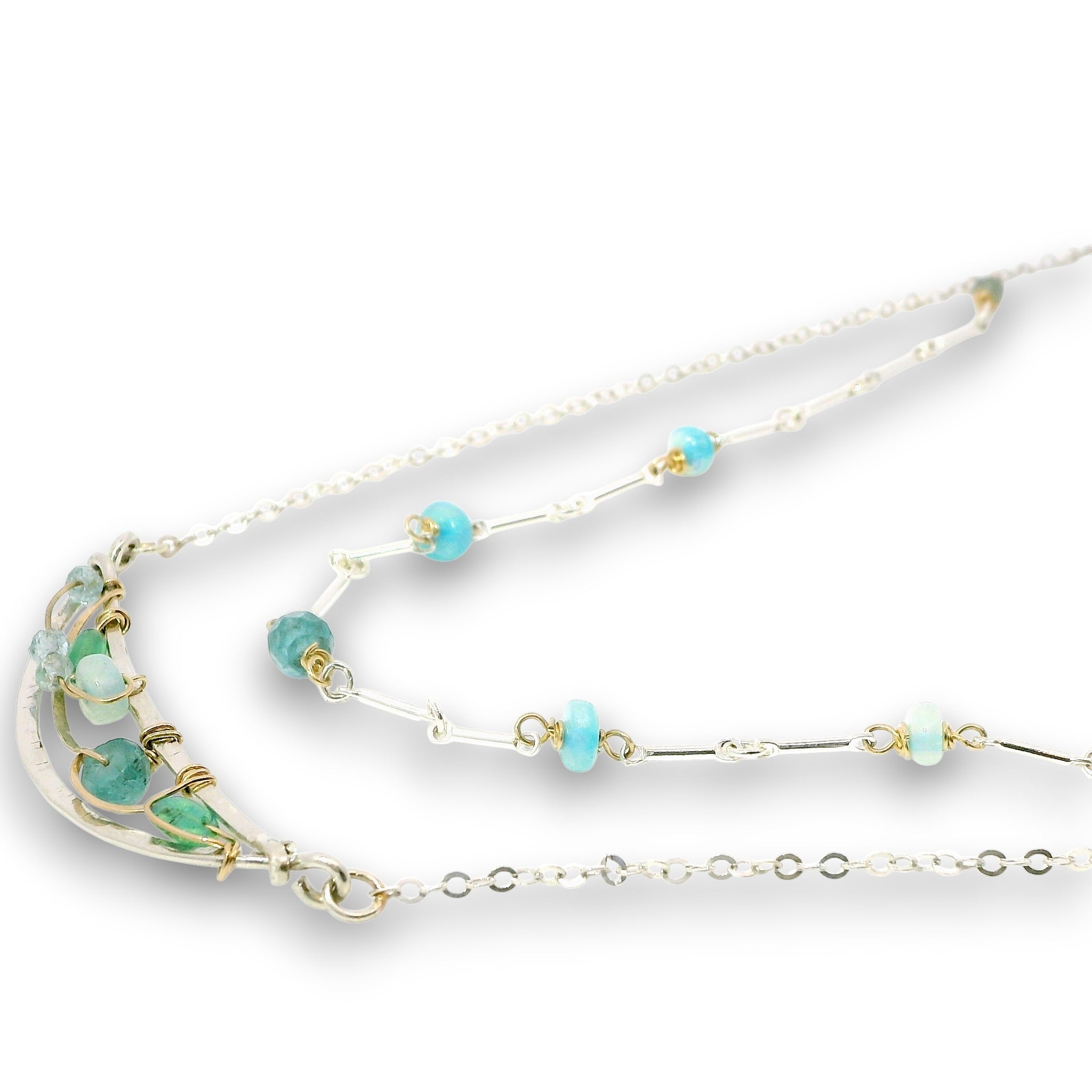 Double layered necklace with the first layer being sterling bar chain with blue opals, the second layer with a sterling moon shaped pendant filled with apatite and bold opal gemstones in 14k gold filled swirls