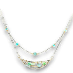Double layered necklace with the first layer being sterling bar chain with blue opals, the second layer with a sterling moon shaped pendant filled with apatite and bold opal gemstones in 14k gold filled swirls