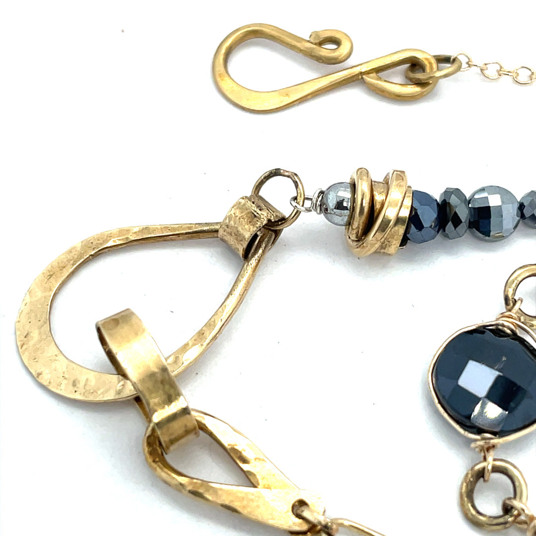 Handmade hammered brass teardrops and straps mixed with pyrite faceted gemstones  to form this double layered necklace on gold filled chain