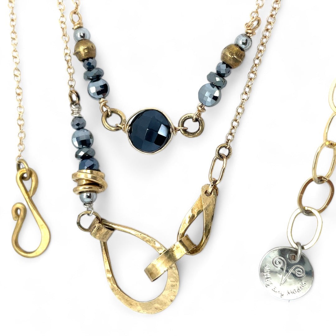 Handmade hammered brass teardrops and straps mixed with pyrite faceted gemstones  to form this double layered necklace on gold filled chain