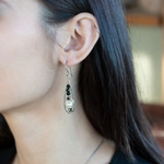 Green goldstone and round fresh water pearls are wrapped in gold filled wire attached to small sterling silver hammered drop earrings