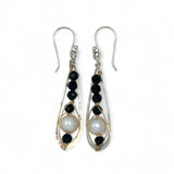 Green goldstone and round fresh water pearls are wrapped in gold filled wire attached to small sterling silver hammered drop earrings