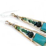 Turquoise smooth rectangles topped with crystal, pyrite, and ruby zoisite gemstones in a long bronze diamond earrings with brass twist accent